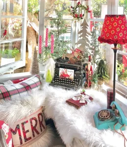 Underwood typewriter and vintage rotary phone with holiday cards and tree figurines