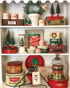 festive flea market finds on display on shelves with vintage tins, ornaments and bottlebrush trees