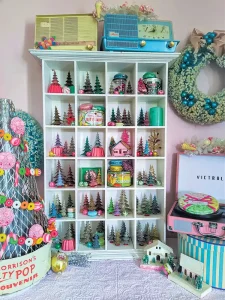 shelf displaying groupings of vintage tree figurines
