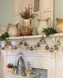 mercury glass ornament wreath and vintage pitcher used as a vase for Christmas greenery