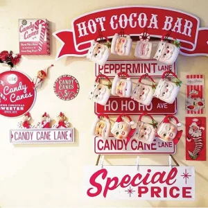 hot cocoa bar with vintage style signs and Santa mugs