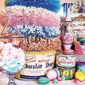 candy shop themed holiday vignette with colorful wreaths and vintage candy tins