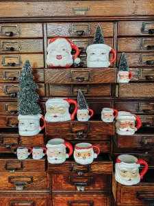 vintage cabinet with collection of Santa mugs