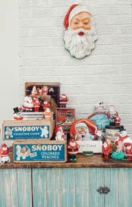 holiday vignette with vintage Santa wall decor, vintage crates and snowmen figurines