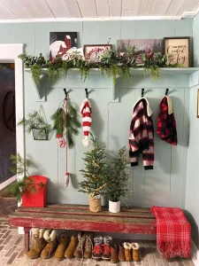 turquoise wall win entryway with fresh greenery and flea market bench