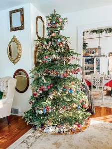 tree decorated with vintage ornaments surrounded by walls with vintage mirrors