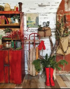 vintage sled as holiday decor along with holly and cedar
