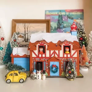 bottlebrush trees and toy house create a Christmas scene