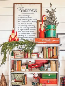 text of The Night Before Christmas on bookshelf decorated with vintage Santa mugs and figurines
