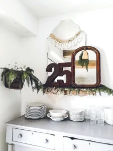 vintage mirrors decorated for Christmas with cedar