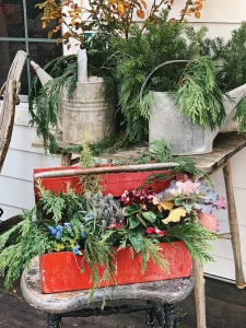 vintage red toolbox with fresh greenery such as cedar
