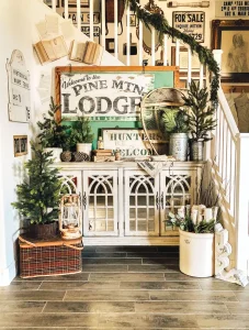 vintage signs and potted trees form holiday vignette