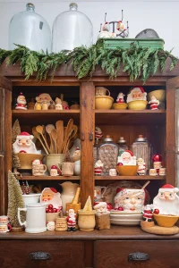 Santa dishes and Santa mugs in hutch among other vintage kitchenalia