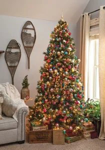 Christmas tree with vintage ornaments and vintage snowshoes on the wall
