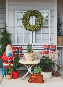 repurposed French doors with wreath and seating area with potted pine trees and a vintage Santa and vintage deer