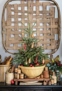 tobacco basket as decor and small tree potted in serving bowl with vintage wooden mini bowling pins as ornaments