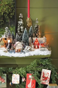 close up on vintage Putz house village with bottlebrush trees and fake snow