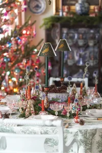Old World holiday tablescape with vintage glassware and fresh greenery