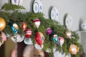 closeup of garland with glass ornaments on top of doorframe