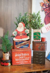 flea market holiday vignette with mini trees in vintage tins