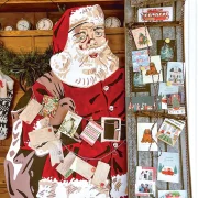 Christmas cards displayed using vintage sled and Santa cutout