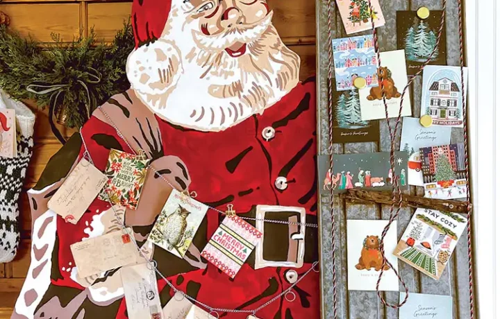Christmas cards displayed using vintage sled and Santa cutout
