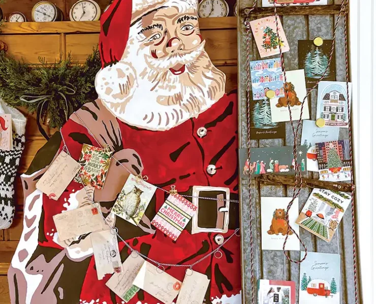 Christmas cards displayed using vintage sled and Santa cutout