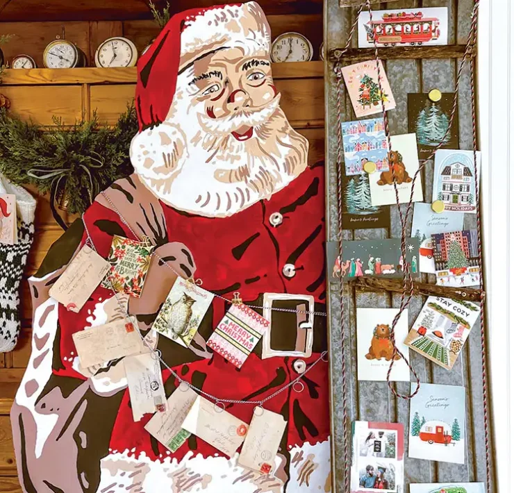 Christmas cards displayed using vintage sled and Santa cutout