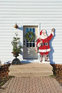 wooden Santa cutout and potted tree at back door of White Cottage Farm