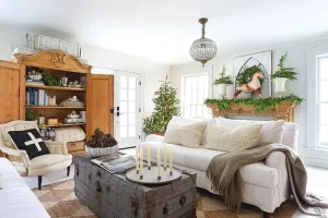 living room with candle wreath Christmas tree and natural greenery on mantel
