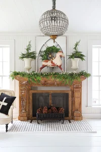 vintage rocking horse on mantel with natural wreath and garland and two potted trees