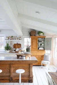 white and wood kitchen with potted mini trees for Christmas