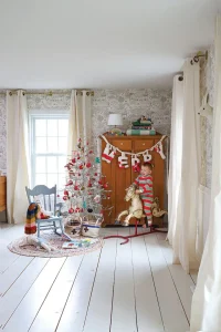 mini tree in neutral holiday home with toddler on rocking horse