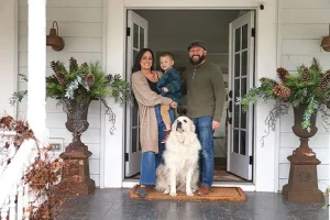 Liz Marie and family outside neutral holiday home