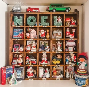 shelf turned advent calendar with vintage holiday figurines