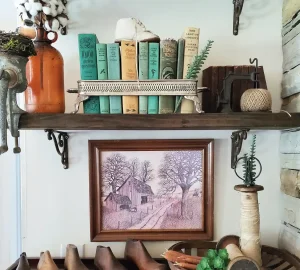 vintage books form a vignette on a bookshelf in an old serving tray
