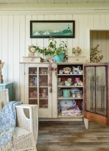cabinets of dishware and collectibles in cottage by the bay