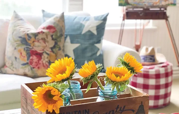 vintage wooden crate displays sunflowers on coffee table in collector's home