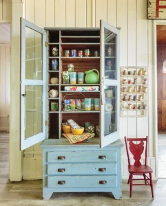 display cabinet with serveware and thread in cottage