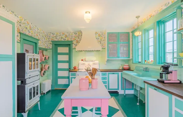 kitchen with scalloped oven hood and vintage inspired pink and mint green color scheme