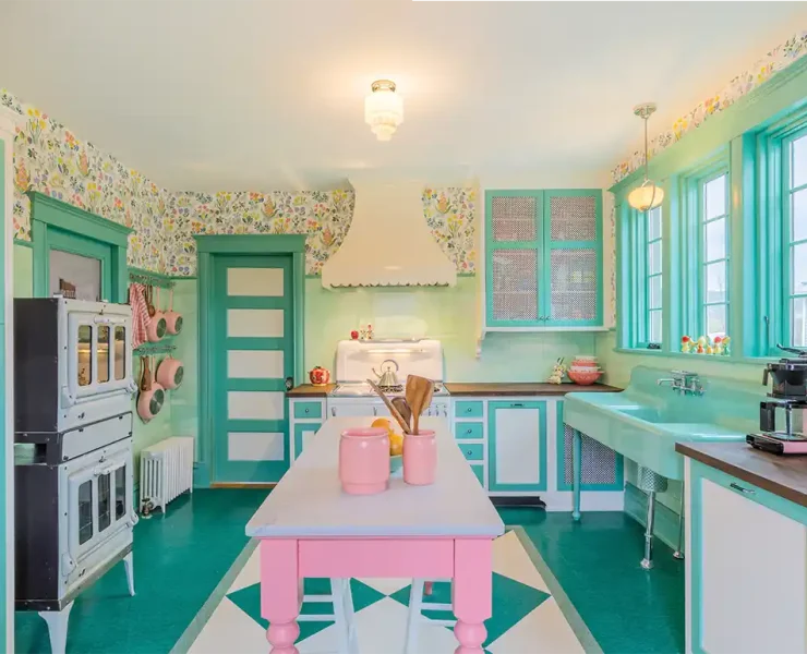 kitchen with scalloped oven hood and vintage inspired pink and mint green color scheme