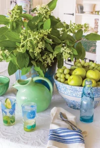 white and blue table with green accents in cottage by the bay