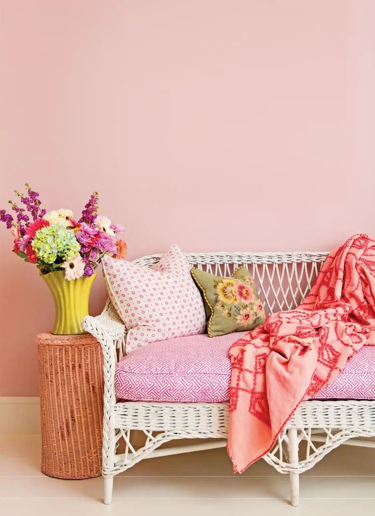 garden-inspired decor with white wicker bench with bright floral cushions